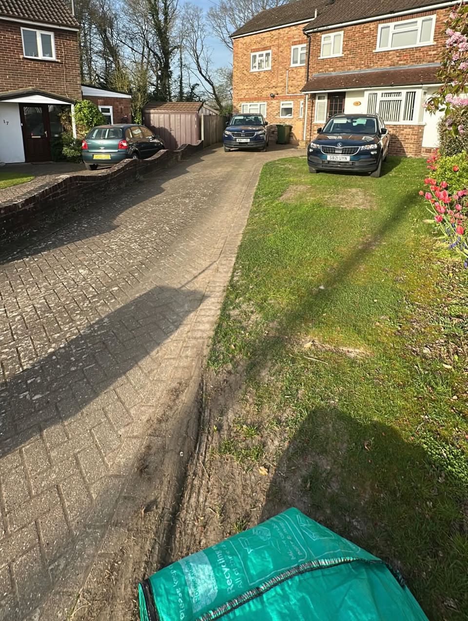 Driveway in Kemsing before the work, with worn paving and patchy grass