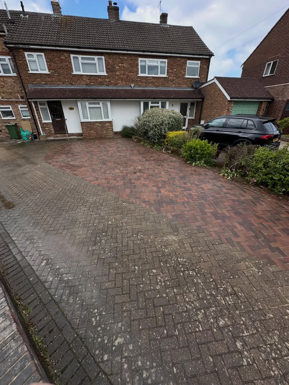Front driveway during renovation showing old and new paving