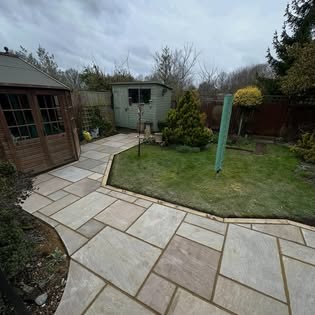 Indian sandstone patio path curving around a lawn